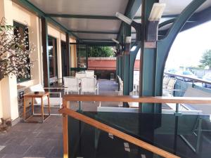 a balcony with tables and chairs on a building at Hotel Sabra in Senigallia