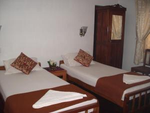 Postel nebo postele na pokoji v ubytování Lazar Residency Homestay