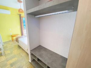 a walk in closet with a bench in it at Panormos Beach Hotel Skopelos in Panormos Skopelos