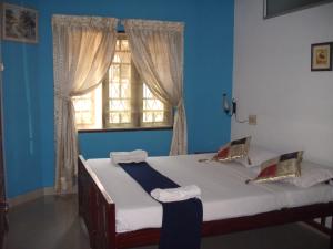 Postel nebo postele na pokoji v ubytování Lazar Residency Homestay