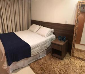 a small bedroom with a bed and a mirror at Village Duplex Confortável e Acolhedor junto a Natureza in Itacimirim +18 photos