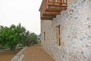 a stone building with a window on the side of it at PIERIDES SUITES in Kardamyli