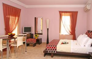 a hotel room with a bed and a table and a desk at PIERIDES SUITES in Kardamyli