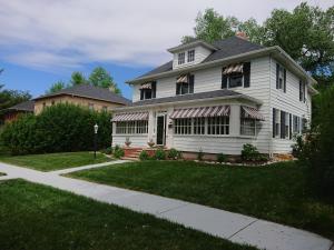 a white house with an awning on it at Governors Home in Cheyenne