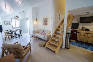 a living room with a staircase leading to a kitchen at Livin Hydra Private Collection Suite 2 in Hydra