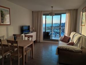 a living room with a table and a couch and a television at Apartamento Duna Beach in Torrox