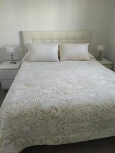 a bedroom with a large bed with two night stands at Apartamento Duna Beach in Torrox