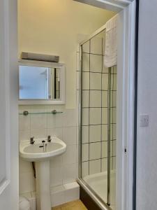 a bathroom with a sink and a shower at Waterfront Inn in Shanklin