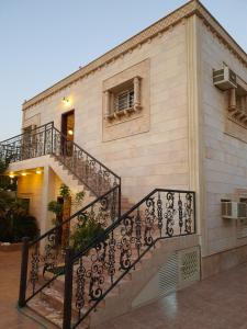un edificio con una escalera delante de él en Villa Ar Rayis Beach, en Rayyis