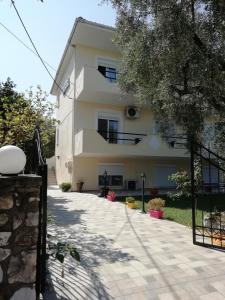 a white building with a staircase in front of it at Tsafas Αpartments in Limenas