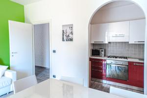 a kitchen with white cabinets and a white counter top at Casa Simone in Malcesine