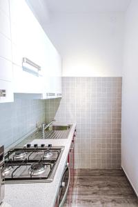 a white kitchen with a stove and a sink at Casa Simone in Malcesine