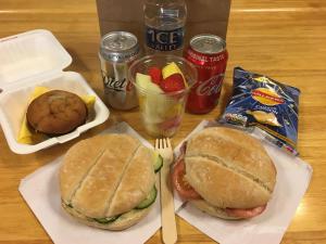 uma mesa com duas sanduíches, snacks e bebidas em Mullacott Farm em Ilfracombe