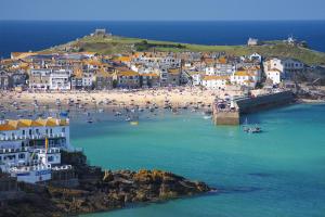 an aerial view of a beach with people in the water at Seaporth Studio St Ives in St Ives