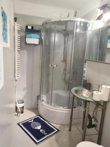 a bathroom with a shower and a sink at Pokoje Malgo Ustka in Ustka +60 photos