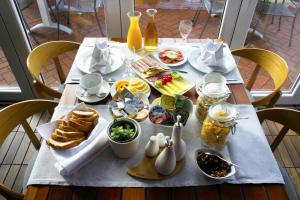 a table with a breakfast of bread and food on it at Apartments Villa Azzurra Bol in Bol