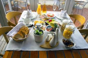 a table with a breakfast of bread and food on it at Apartments Villa Azzurra Bol in Bol