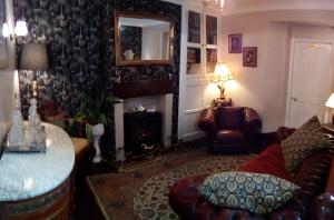 a living room with a couch and a fireplace at Belvedere House in Middleton in Teesdale