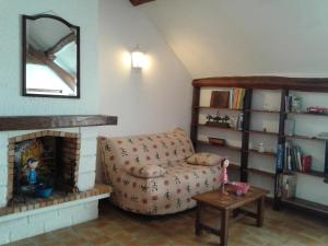 a living room with a couch and a fireplace at Au Grand Sapin Chambres chez l'habitant in Hénonville