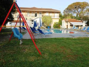 a swing in a yard next to a pool at Panagiotis I & II Stds and Apts in Tsilivi