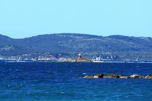 a lighthouse in the middle of a body of water at Appartamenti Sole in Alghero