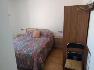 a small bedroom with a bed and a dresser at Apartamento rural en bronchales, Sierra de Albarracín in Bronchales
