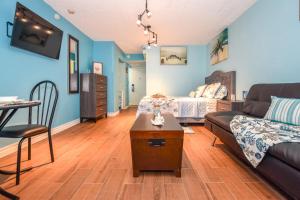 a living room with a couch and a table at Daytona Condo with Beautiful Ocean and City View in Daytona Beach