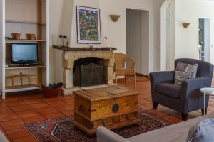 a living room with a fireplace and a tv at Marchanta in Santarém