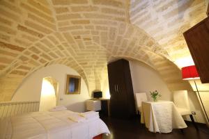 una camera con un letto in una stanza con soffitto in pietra di Bed & Breakfast Idomeneo 63 a Lecce