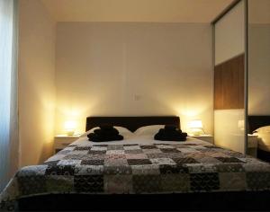 a bedroom with a bed with two bags on it at Apartment Joia on the beach Bačvice in Split