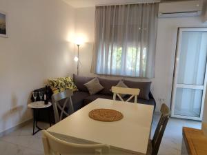 a living room with a couch and a table at Deluxe Apartment Joia with balcony near Old Town and Bacvice Beach in Split
