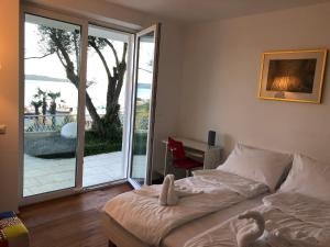 a bedroom with a bed and a sliding glass door at Portorož Apartments in Portorož +62 photos