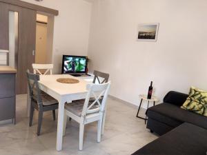 a living room with a white table and chairs at Apartment Joia on the beach Bačvice in Split