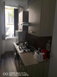a kitchen with a stove and a sink and a window at Trastevere four seasons Glorioso in Rome