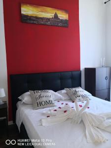 a bedroom with a bed with a red wall at St. Peter's Luxury House in Rome