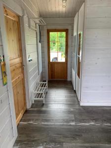 a hallway of a house with a wooden door at VITA Ruokolahti 3 in Ruokolahti