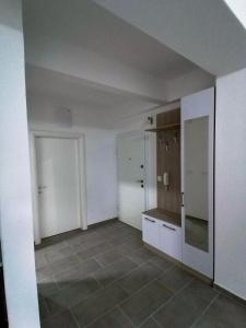 a kitchen with white cabinets and a tiled floor at Apartments st.Martinia in Ohrid