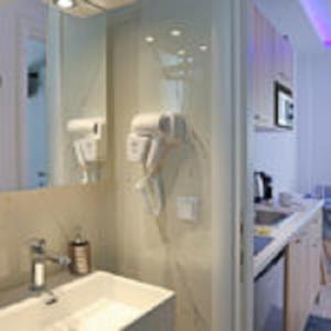 a bathroom with a shower with a sink and a mirror at SunsetPeramos in Nea Peramos +72 photos