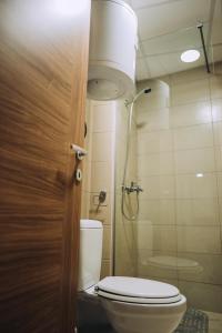 a small bathroom with a toilet and a shower at SANA Apartments in Ohrid