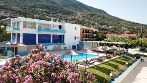 a resort with a swimming pool and a mountain at Surf Hotel in Vasiliki