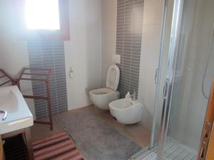 a bathroom with a toilet and a sink and a shower at Aganis in Casarsa della Delizia