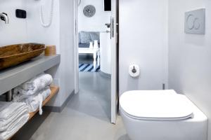 a white bathroom with a toilet and a sink at Spitaki Serifos Studio in Rámos +37 photos