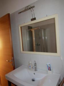 a bathroom with a sink and a mirror at Aganis in Casarsa della Delizia