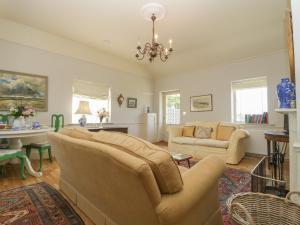a living room with two couches and a table at Mappowder Cottage in Sturminster Newton