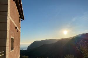 a view of the sun setting over the mountains at Agriturismo Missanega in Monterosso al Mare