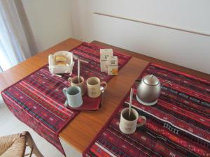 a table with cups and a tray of food on it at Aganis in Casarsa della Delizia