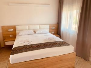 a bedroom with a bed with two towels on it at Apartments Knežević in Ulcinj
