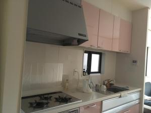 a kitchen with pink cabinets and a counter top at SUMIDA in Osaka