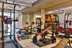 a gym with a lot of treadmills and machines at Boutique Hotel Tate By Aycon in Budva