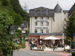 a building with people sitting at tables on a street at Hotel Belle Vue in Vianden